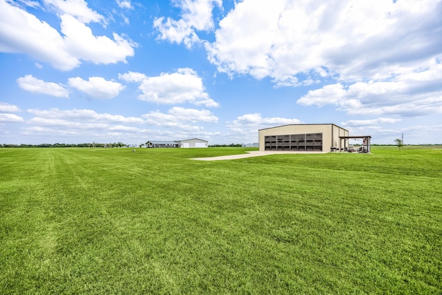 view of yard featuring an outbuilding, an outdoor structure, and a garage