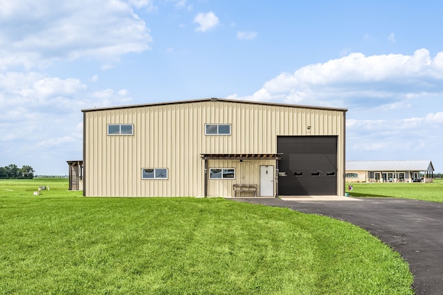 view of outbuilding featuring an outbuilding and aphalt driveway