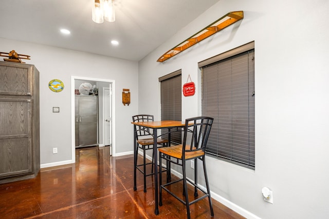 dining area featuring concrete flooring, baseboards, and recessed lighting