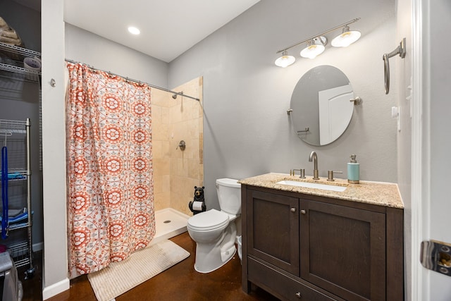 bathroom with concrete flooring, toilet, vanity, and tiled shower
