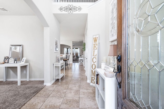 3901 Penny Ln, Deer Park, TX 77536 - entrance foyer featuring arched walkways, baseboards, and light tile patterned flooring