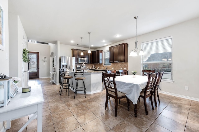 3901 Penny Ln, Deer Park, TX 77536 - dining area featuring arched walkways, recessed lighting, baseboards, and light tile patterned floors