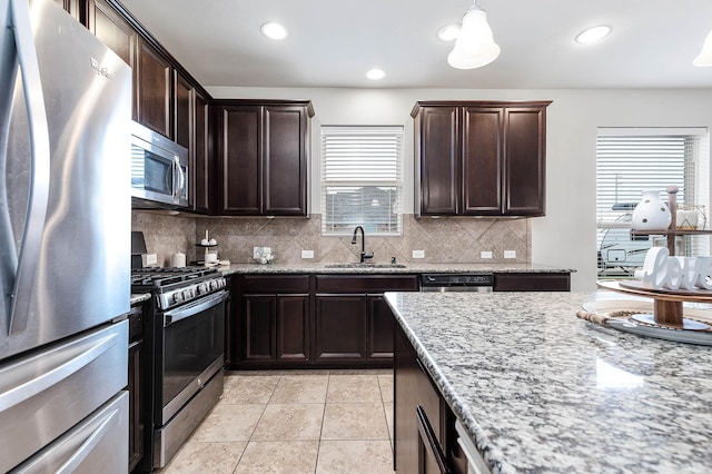 3901 Penny Ln, Deer Park, TX 77536 - kitchen with appliances with stainless steel finishes, a sink, healthy amount of natural light, backsplash, and recessed lighting
