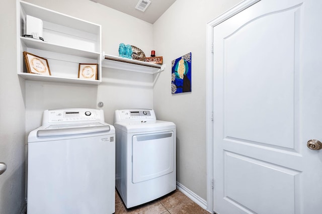 3901 Penny Ln, Deer Park, TX 77536 - laundry area featuring washing machine and clothes dryer, tile patterned flooring, and baseboards