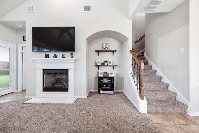 3901 Penny Ln, Deer Park, TX 77536 - living room with stairs, a fireplace with raised hearth, carpet floors, and baseboards