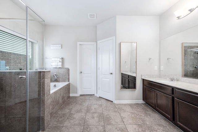 3901 Penny Ln, Deer Park, TX 77536 - full bathroom with a shower stall, a garden tub, vanity, baseboards, and tile patterned floors