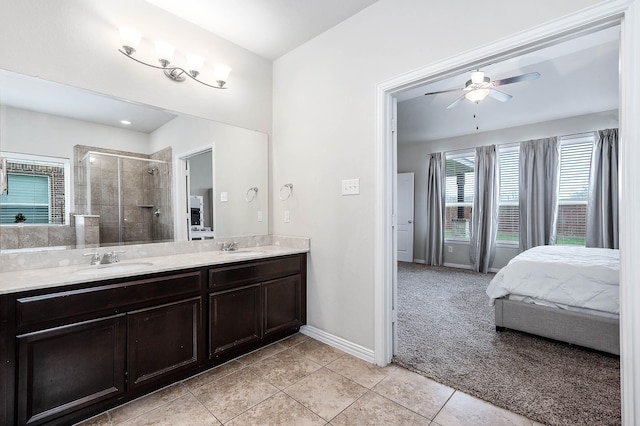 3901 Penny Ln, Deer Park, TX 77536 - ensuite bathroom with tile patterned flooring, a stall shower, ceiling fan, double vanity, and baseboards