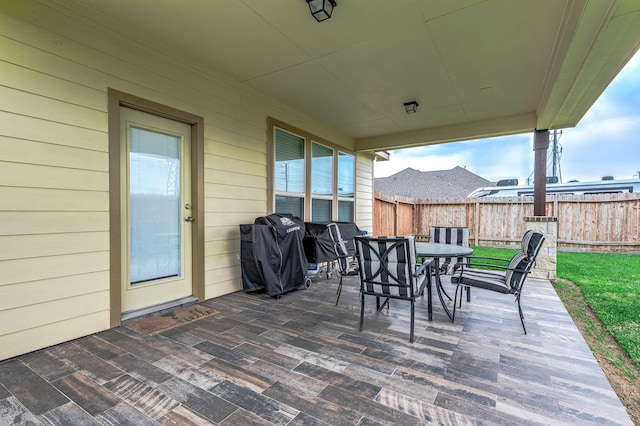 3901 Penny Ln, Deer Park, TX 77536 - view of patio featuring outdoor dining space, fence, and area for grilling