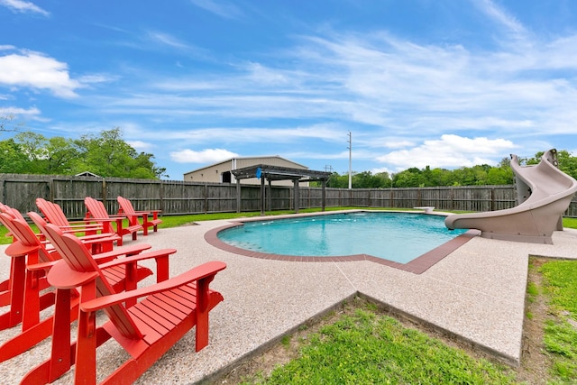 view of swimming pool featuring a fenced in pool, a patio area, a water slide, and a fenced backyard