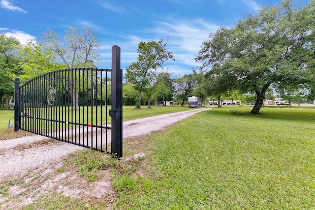view of gate featuring a lawn