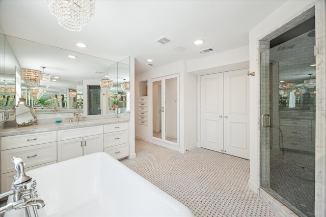 2129 Brentwood Dr, Houston, TX 77019 - full bathroom featuring recessed lighting, a shower stall, an inviting chandelier, a freestanding bath, and vanity