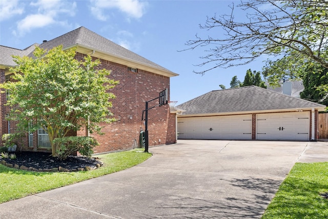 1509 Shamrock Ln, Deer Park, TX 77536 - view of home's exterior with brick siding, roof with shingles, and a detached garage