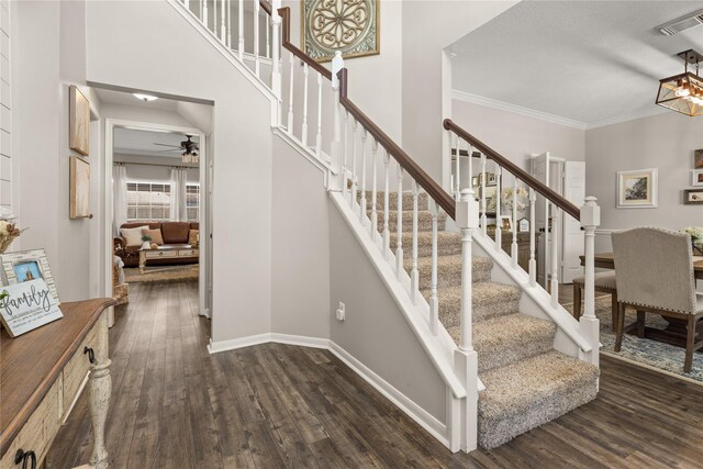 1509 Shamrock Ln, Deer Park, TX 77536 - staircase with wood finished floors, crown molding, ceiling fan, baseboards, and a chandelier