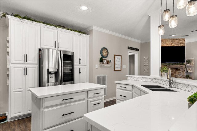 1509 Shamrock Ln, Deer Park, TX 77536 - kitchen featuring stainless steel fridge with ice dispenser, a sink, crown molding, dark wood-style flooring, and white cabinets