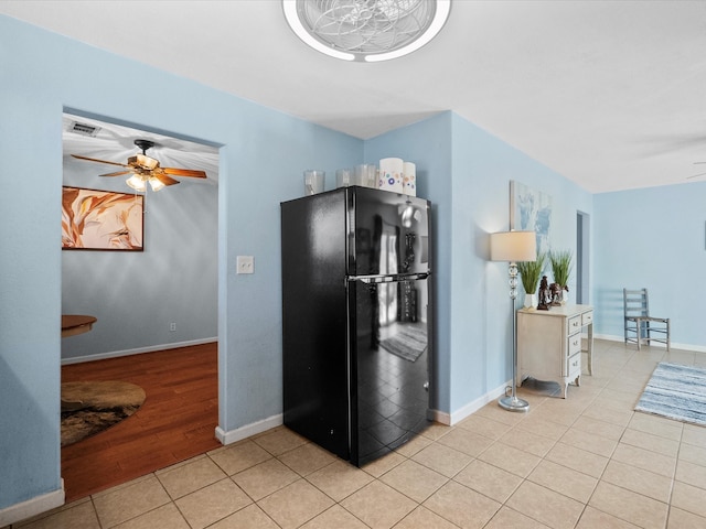 1901 49th St, Galveston, TX 77551 - kitchen with visible vents, light tile patterned floors, freestanding refrigerator, baseboards, and ceiling fan