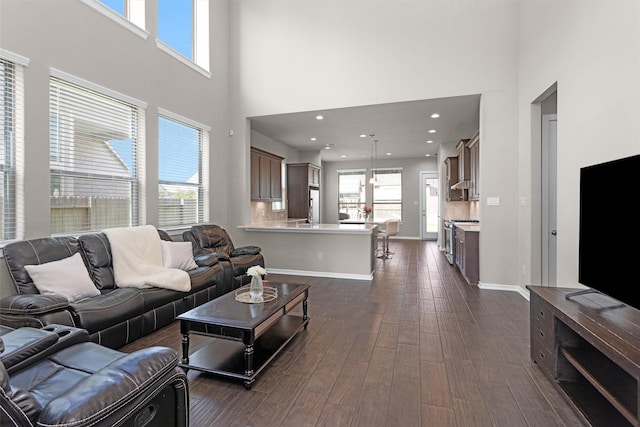 17318 Autumn Sage Ct, Conroe, TX 77385 - living area featuring baseboards, recessed lighting, a towering ceiling, and dark wood-style floors