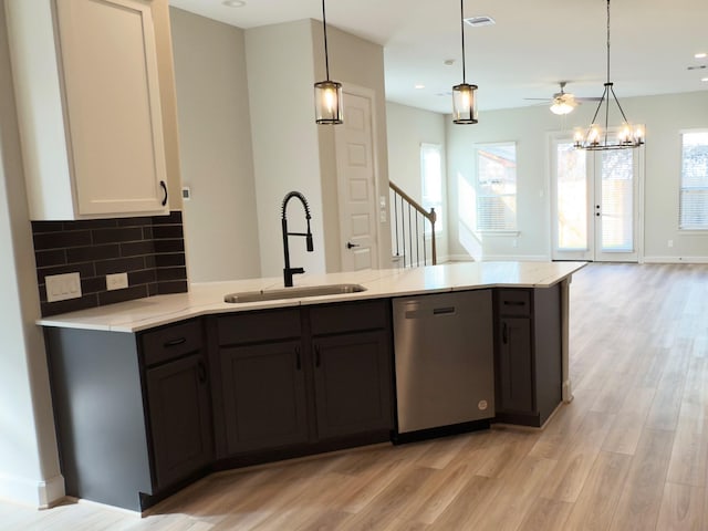 1106 Adele St, Houston, TX 77009 - kitchen featuring a sink, pendant lighting, light wood-type flooring, and dishwasher