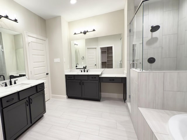 1106 Adele St, Houston, TX 77009 - bathroom with a sink, a shower stall, a bathing tub, two vanities, and baseboards