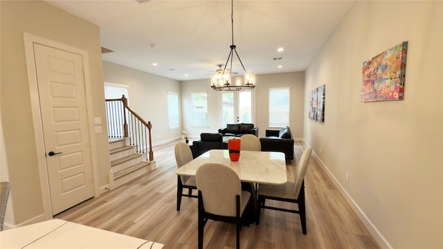 1106 Adele St, Houston, TX 77009 - dining area with recessed lighting, baseboards, light wood finished floors, an inviting chandelier, and stairs