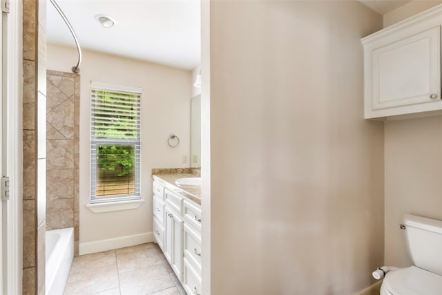 21014 Angus Dr, Cleveland, TX 77328 - bathroom featuring tile patterned flooring, toilet, vanity, tub / shower combination, and baseboards