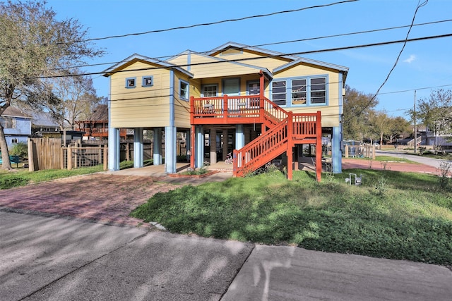 631 Clear Lake Rd, Galveston, TX 77565 - back of property with a porch, a carport, stairway, and decorative driveway