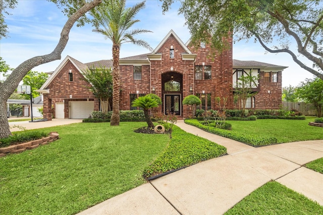 14 Tredington St, Sugar Land, TX 77479 - view of front facade with driveway, brick siding, and a garage