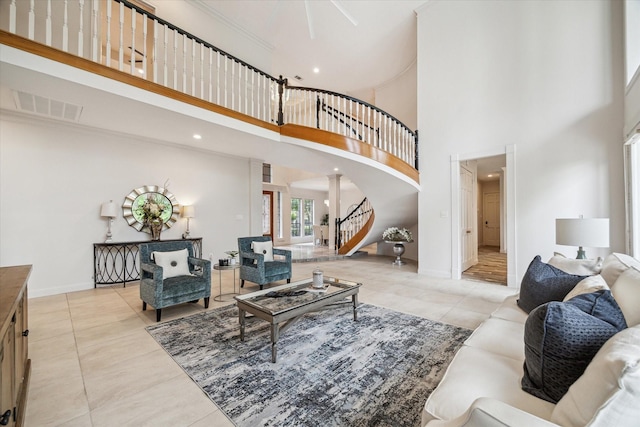 14 Tredington St, Sugar Land, TX 77479 - living room with a towering ceiling, stairway, tile patterned floors, baseboards, and ornate columns