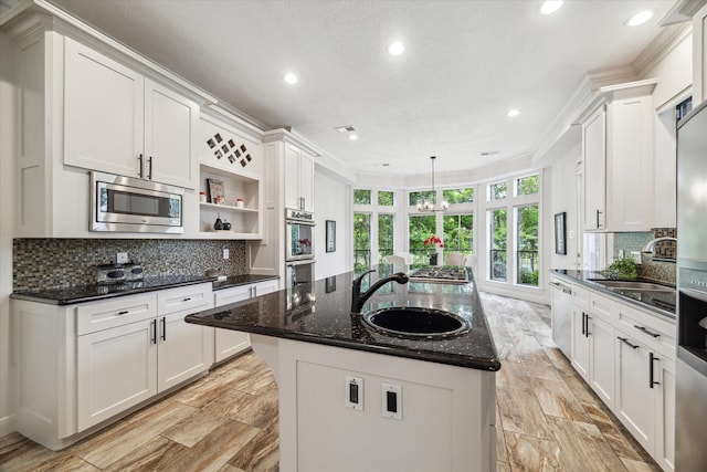 14 Tredington St, Sugar Land, TX 77479 - kitchen featuring appliances with stainless steel finishes, a sink, recessed lighting, a center island with sink, and white cabinetry