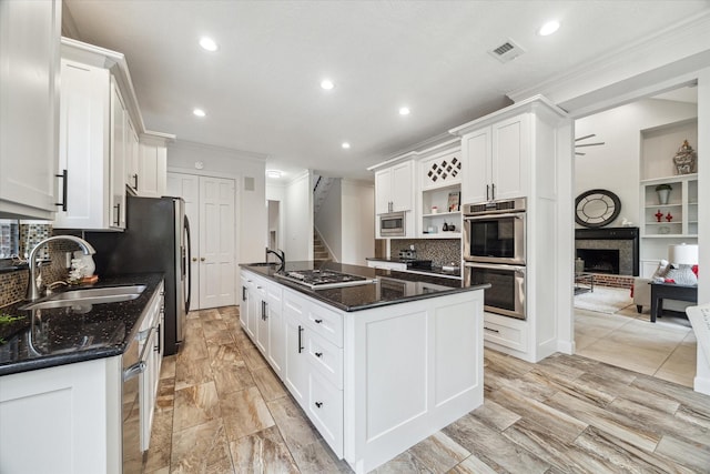 14 Tredington St, Sugar Land, TX 77479 - kitchen with stainless steel appliances, a sink, ornamental molding, open shelves, and recessed lighting