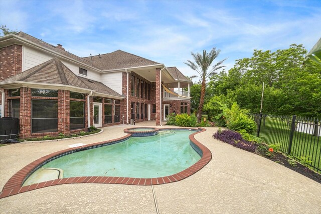 14 Tredington St, Sugar Land, TX 77479 - view of swimming pool with fence, a patio area, and a pool with connected hot tub