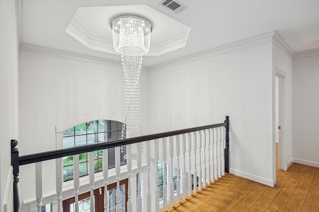 14 Tredington St, Sugar Land, TX 77479 - hall with a chandelier, healthy amount of natural light, wood finished floors, an upstairs landing, and crown molding