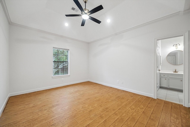 14 Tredington St, Sugar Land, TX 77479 - unfurnished bedroom with crown molding, light wood finished floors, baseboards, a sink, and ensuite bath