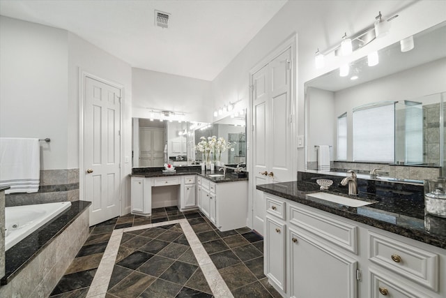 14 Tredington St, Sugar Land, TX 77479 - full bathroom with a bath, two vanities, and stone tile floors