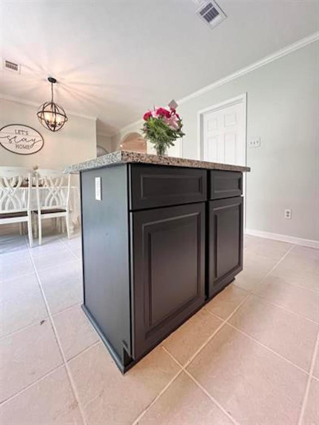 kitchen with light stone countertops, visible vents, crown molding, and light tile patterned floors