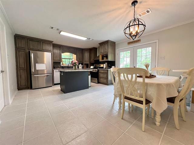 kitchen with stainless steel appliances, french doors, visible vents, a chandelier, and crown molding