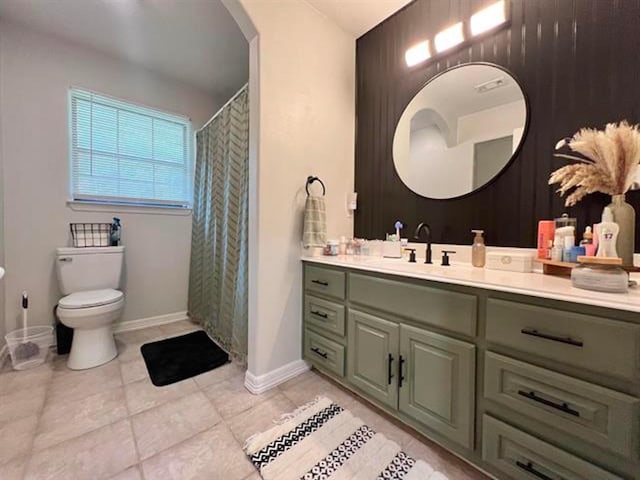 bathroom featuring tile patterned flooring, baseboards, toilet, and vanity