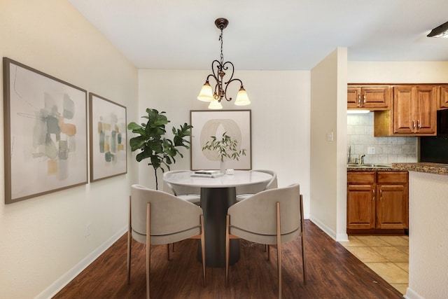 904 University Oaks Blvd Unit 92, College Station, TX 77840 - dining space with light wood-style flooring, baseboards, and an inviting chandelier