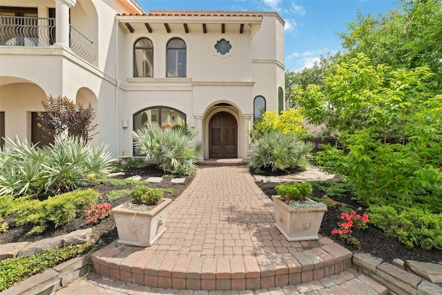 exterior space featuring stucco siding and a balcony