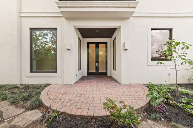 doorway to property with french doors and stucco siding