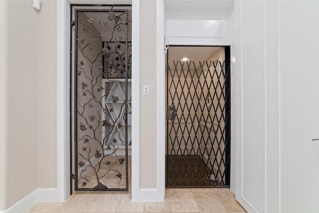 bathroom with elevator and baseboards