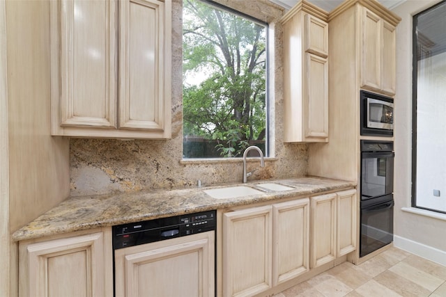 kitchen with dobule oven black, a sink, light brown cabinetry, dishwasher, and stainless steel microwave