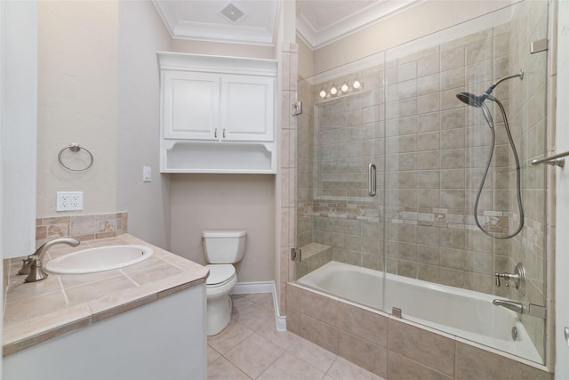 bathroom with crown molding, tile patterned floors, tiled shower / bath combo, toilet, and visible vents