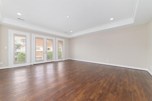 unfurnished room with plenty of natural light, ornamental molding, and a raised ceiling