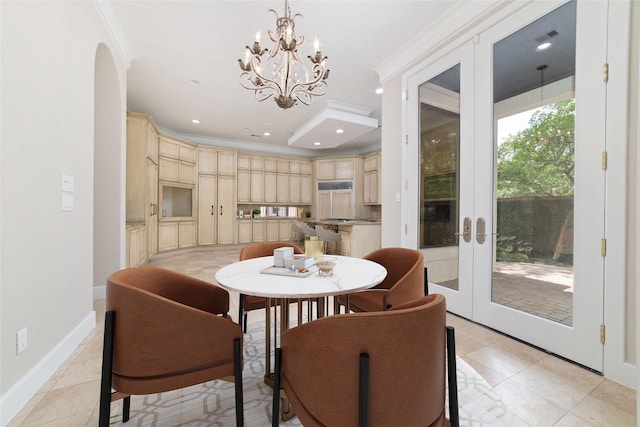 dining space featuring french doors, baseboards, a chandelier, and ornamental molding