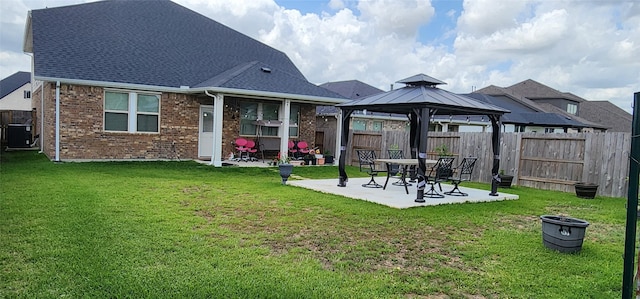 19210 Palfrey Prairie Trl, Tomball, TX 77377 - rear view of house with a yard, a patio, a gazebo, and a fenced backyard