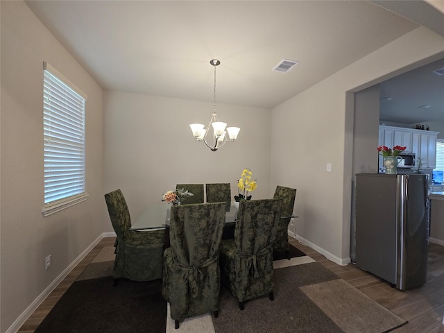 19210 Palfrey Prairie Trl, Tomball, TX 77377 - dining area with a chandelier, visible vents, a healthy amount of sunlight, and wood finished floors