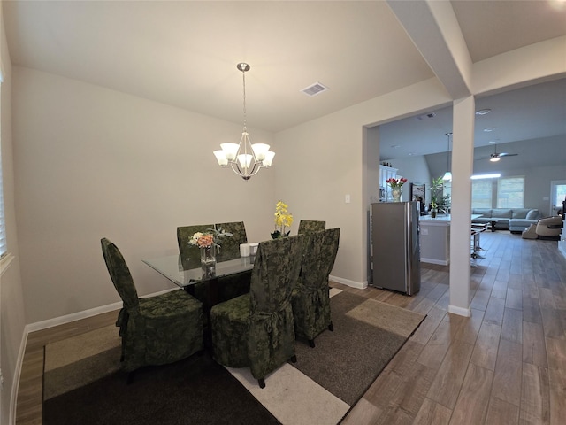 19210 Palfrey Prairie Trl, Tomball, TX 77377 - dining space featuring baseboards, ceiling fan with notable chandelier, wood finished floors, and visible vents