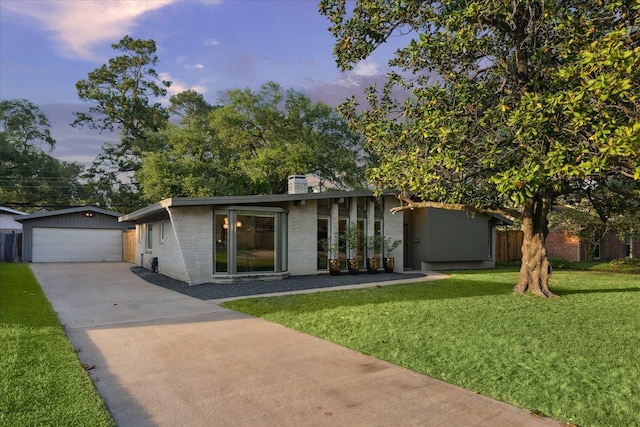 10134 Eddystone Dr, Houston, TX 77043 - view of front facade with a detached garage, a chimney, brick siding, an outdoor structure, and a front yard