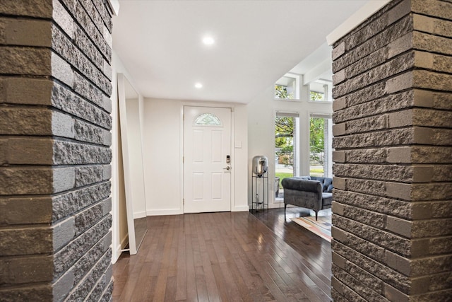 10134 Eddystone Dr, Houston, TX 77043 - foyer with brick wall, baseboards, recessed lighting, and dark wood finished floors