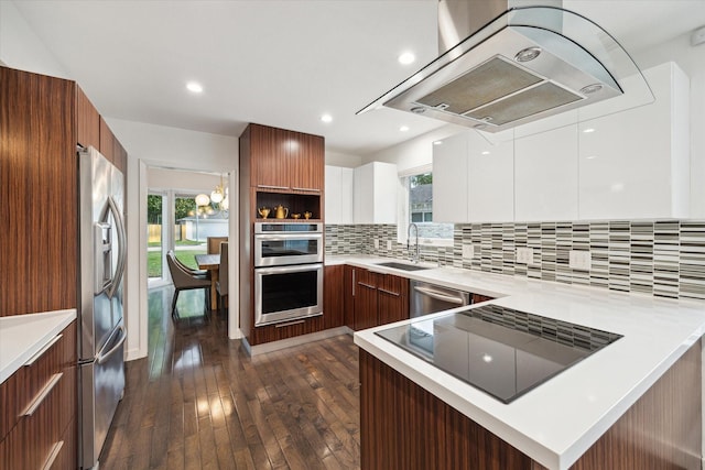 10134 Eddystone Dr, Houston, TX 77043 - kitchen with dark wood-style floors, exhaust hood, light countertops, modern cabinets, and appliances with stainless steel finishes